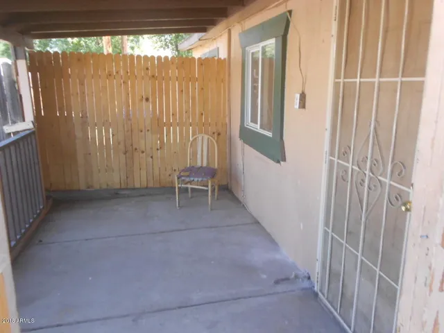 a view of a porch with a door and chair