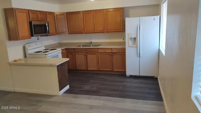 a kitchen with a refrigerator sink and microwave
