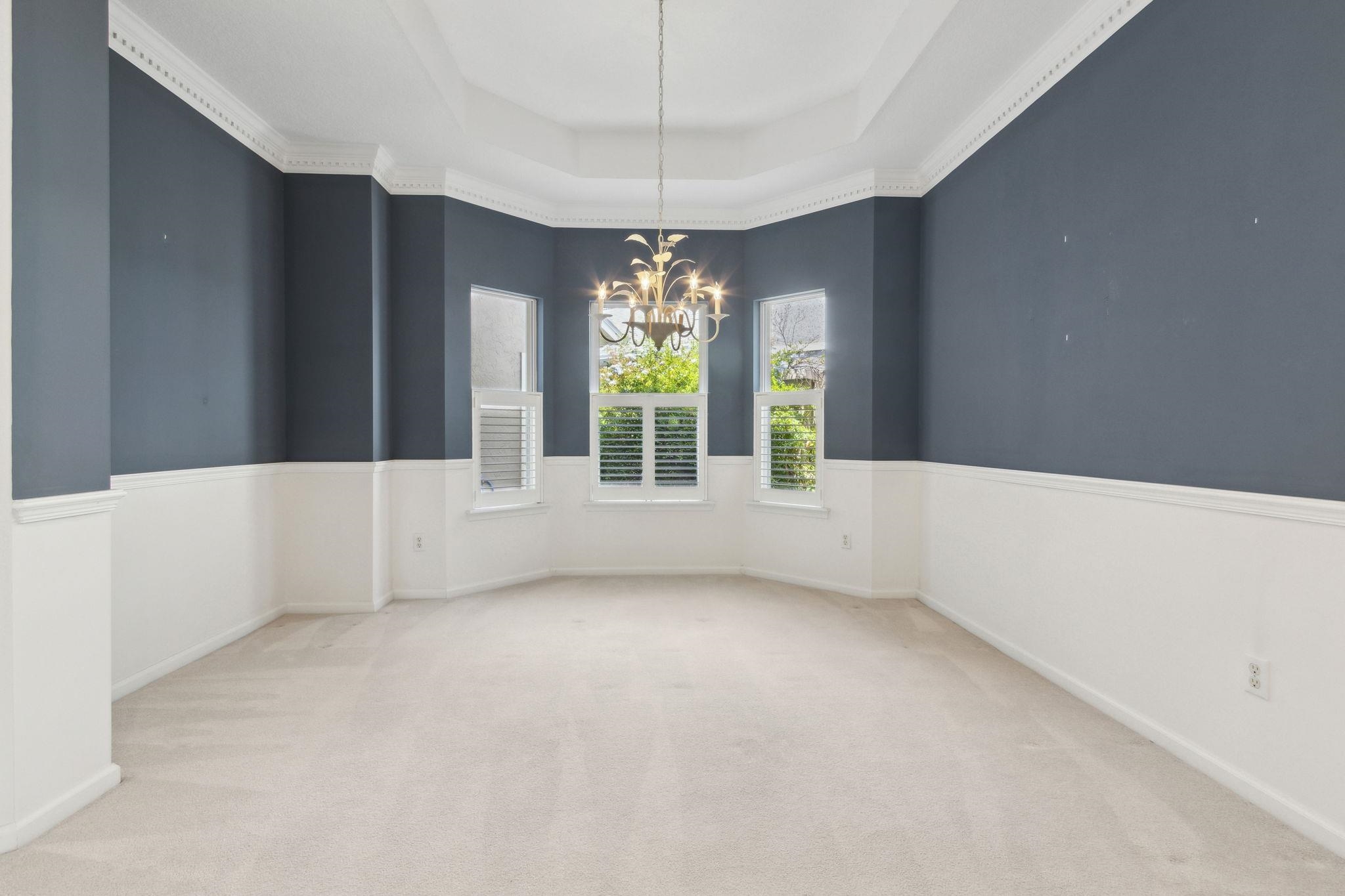 908 Birdie Way St. Augustine, FL 32080 - Photo 13 of 68 a view of an empty room with window and chandelier