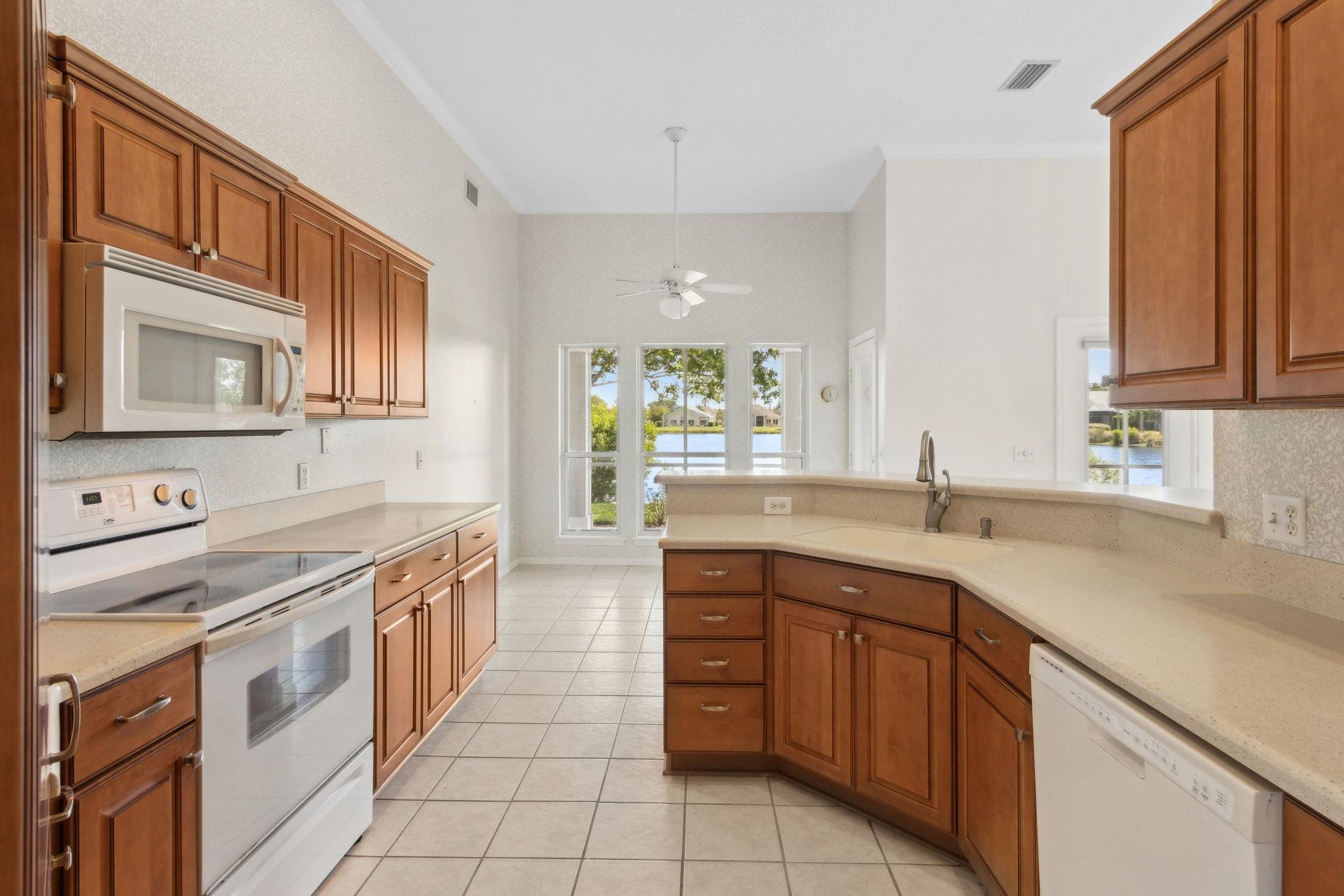 908 Birdie Way St. Augustine, FL 32080 - Photo 17 of 68 a kitchen with a sink stove and cabinets