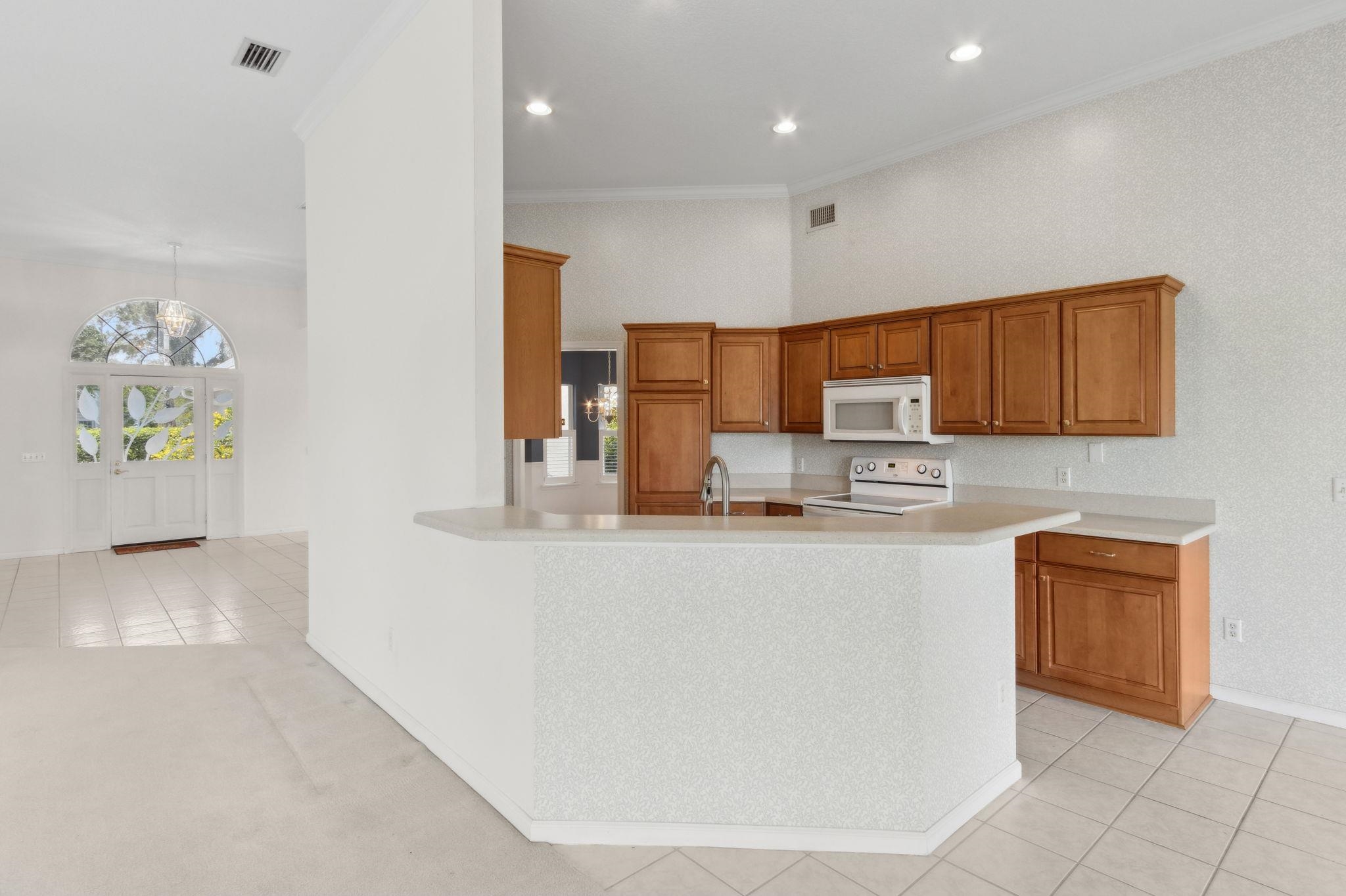 908 Birdie Way St. Augustine, FL 32080 - Photo 19 of 68 a kitchen with stainless steel appliances granite countertop a refrigerator a stove top oven a sink and dishwasher