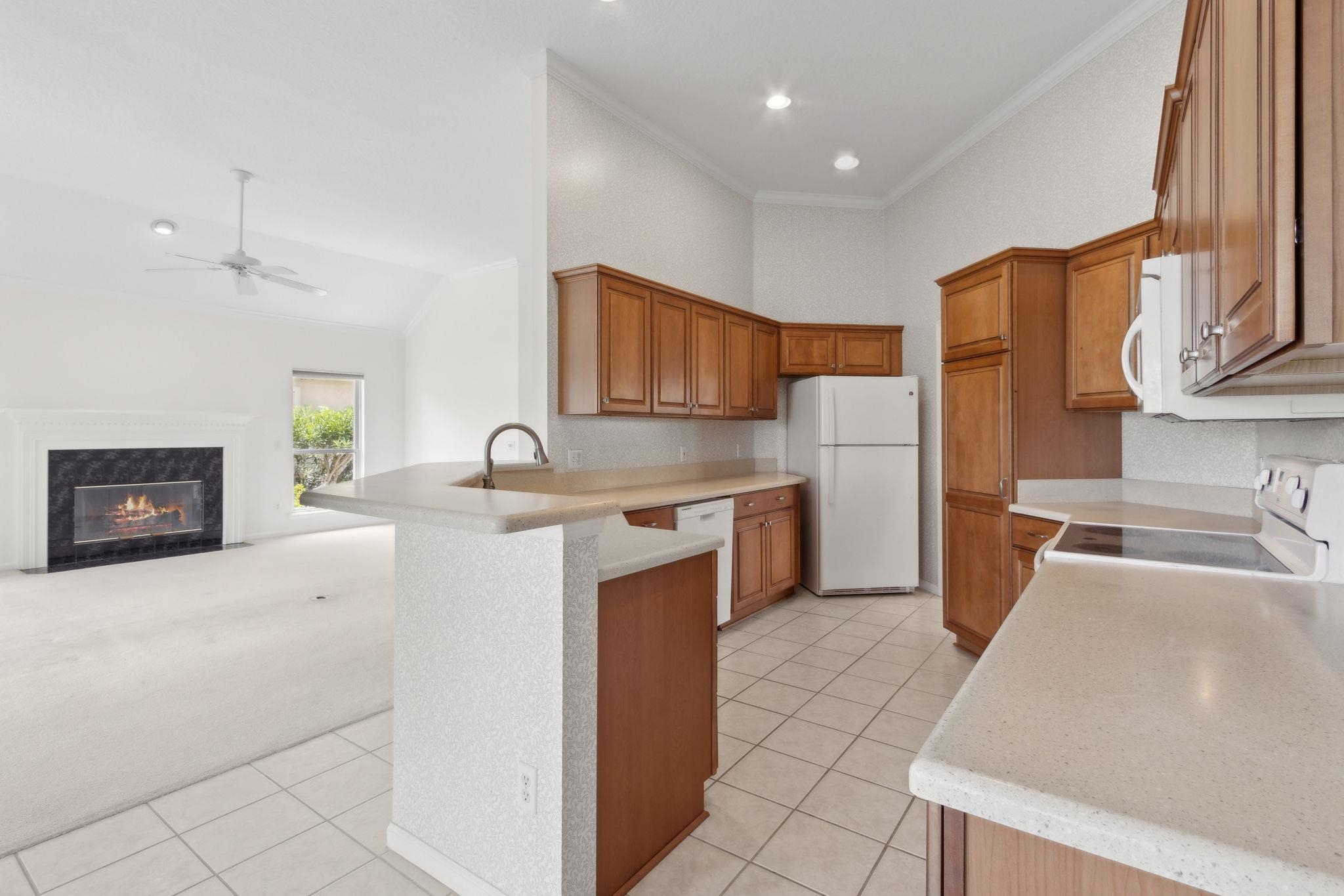 908 Birdie Way St. Augustine, FL 32080 - Photo 20 of 68 a kitchen with stainless steel appliances a stove a sink and a refrigerator