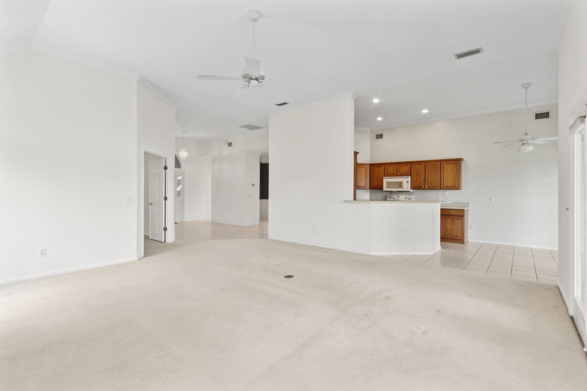 908 Birdie Way St. Augustine, FL 32080 - Photo 26 of 68 an empty room with a kitchen and a window
