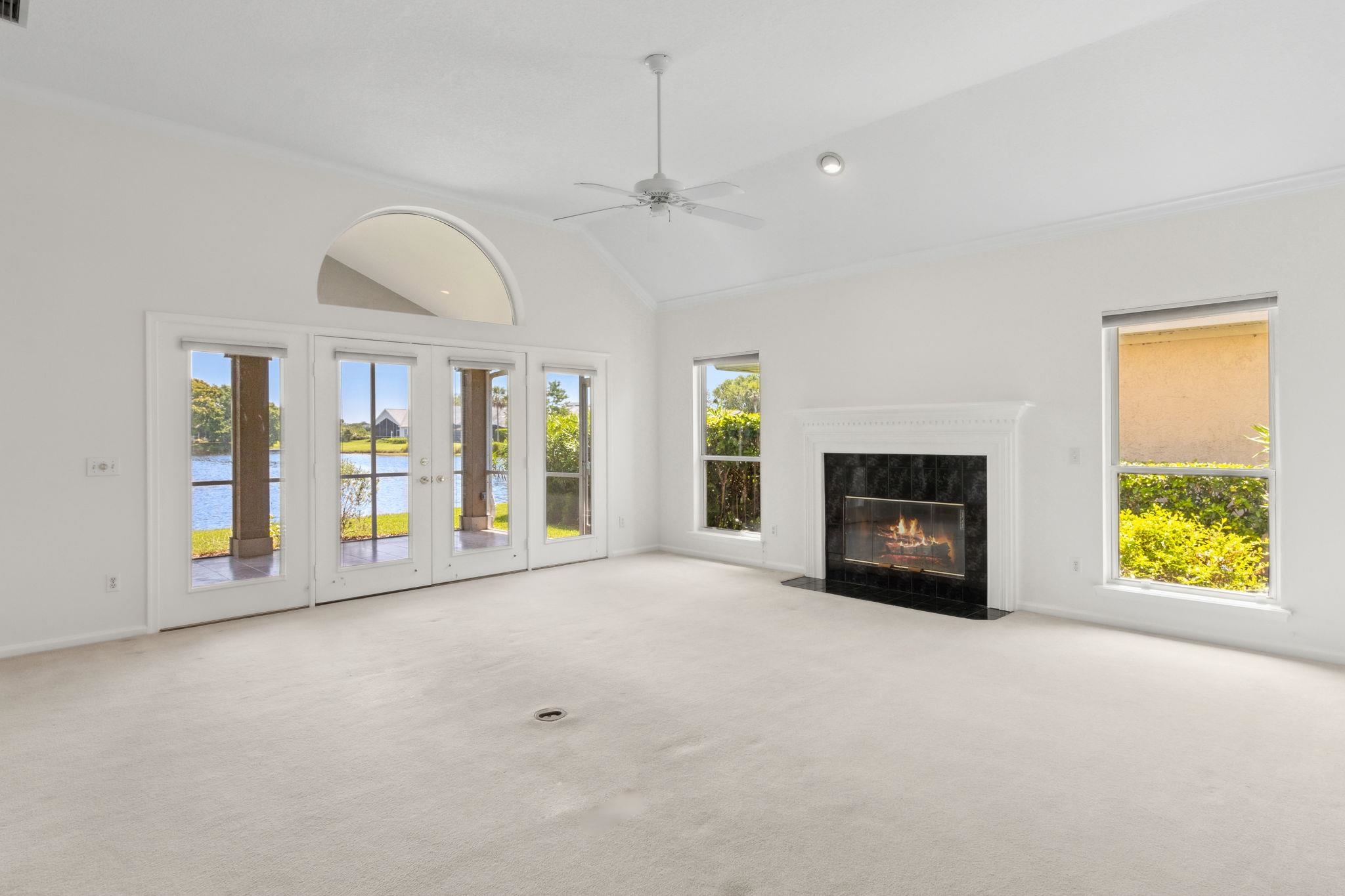 908 Birdie Way St. Augustine, FL 32080 - Photo 27 of 68 a view of an empty room with a fireplace and a window
