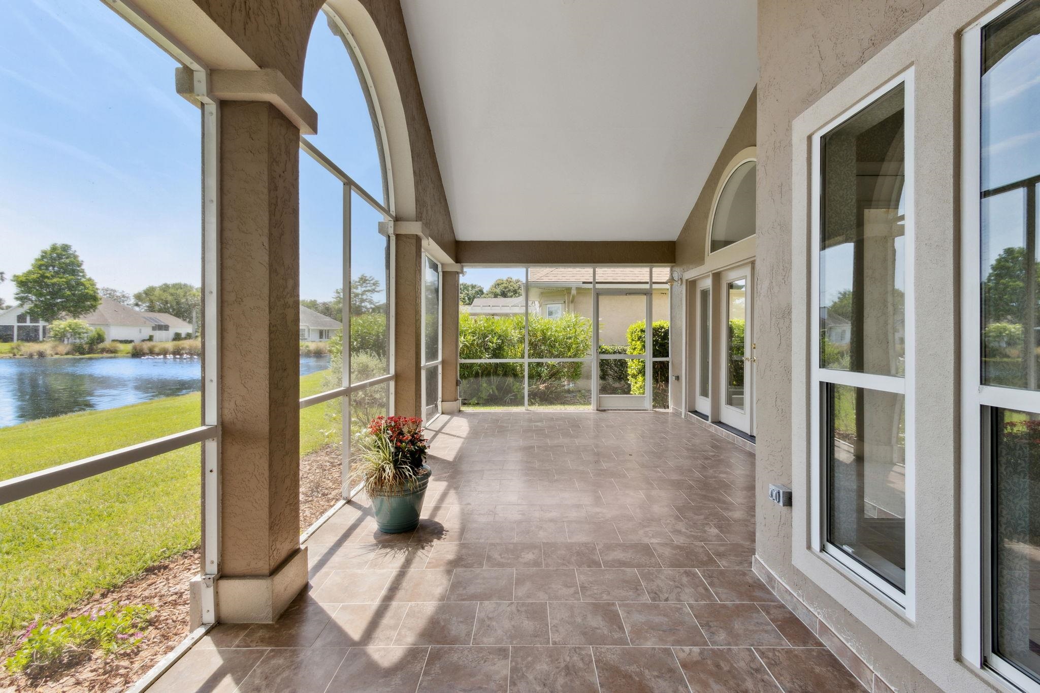 908 Birdie Way St. Augustine, FL 32080 - Photo 30 of 68 a view of porch with a floor to ceiling window next to a yard