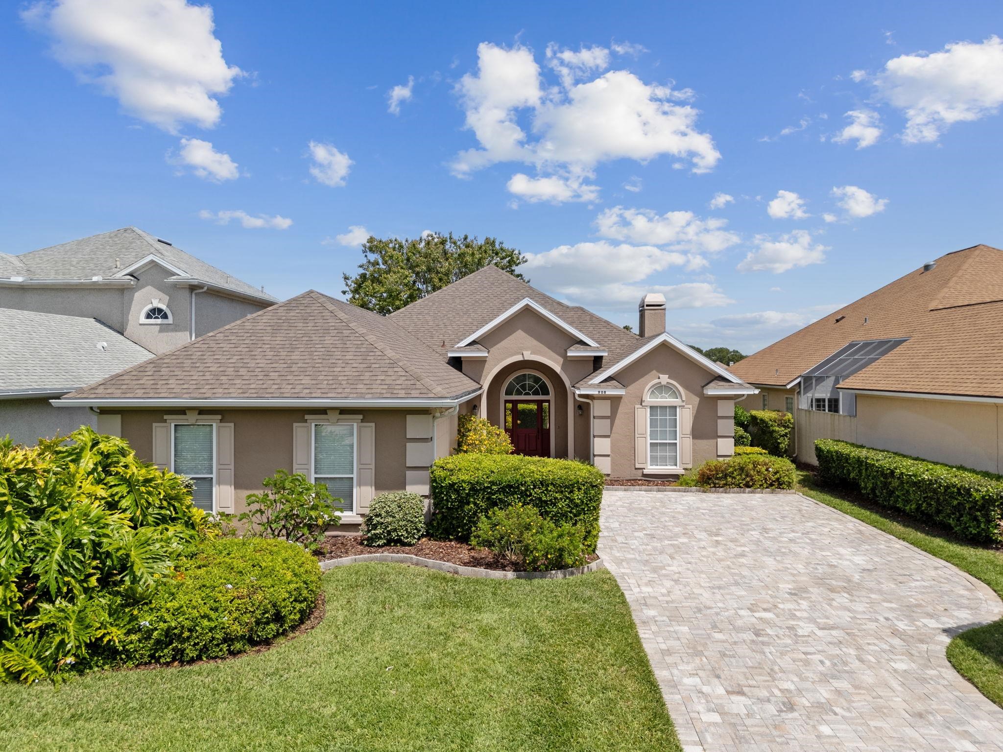 908 Birdie Way St. Augustine, FL 32080 - Photo 3 of 68 a front view of a house with a yard