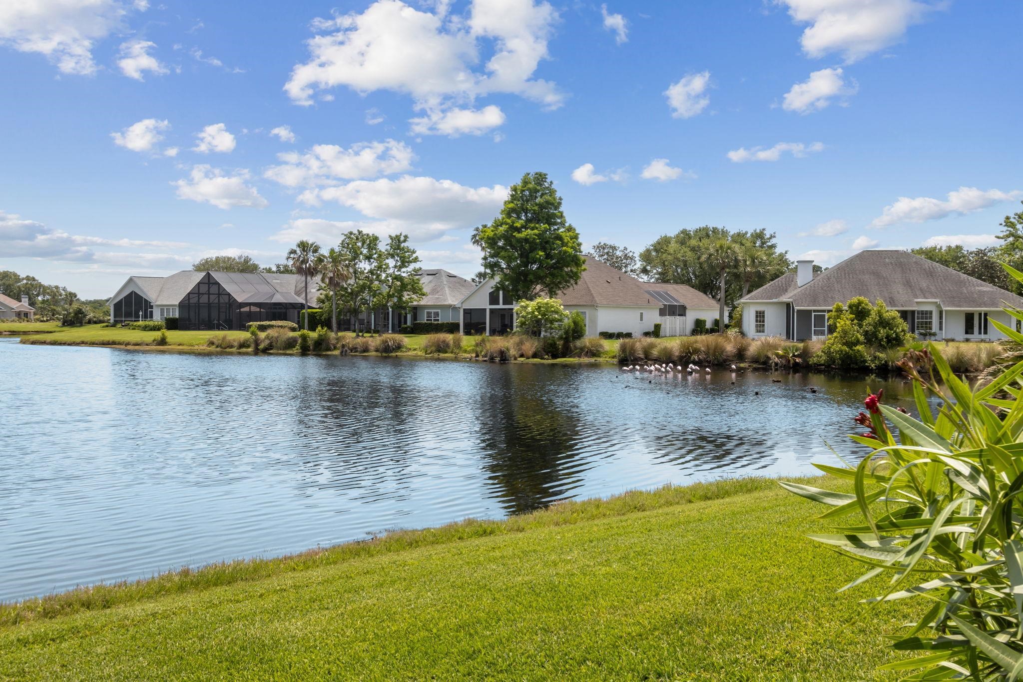 908 Birdie Way St. Augustine, FL 32080 - Photo 32 of 68 a view of a lake with houses in the back