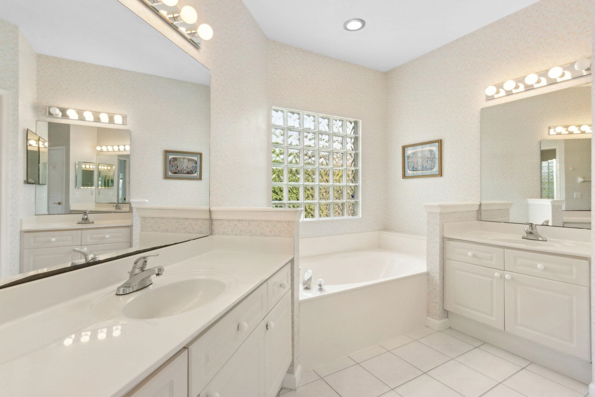 908 Birdie Way St. Augustine, FL 32080 - Photo 42 of 68 a bathroom with a bathtub sink and mirror