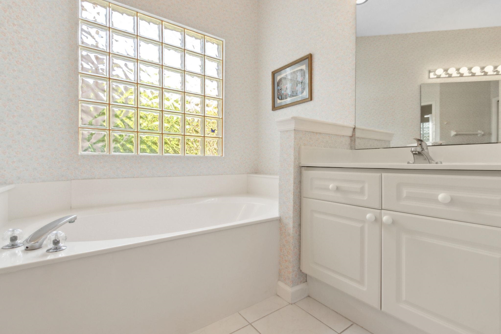 908 Birdie Way St. Augustine, FL 32080 - Photo 43 of 68 a bathroom with a bathtub and a sink