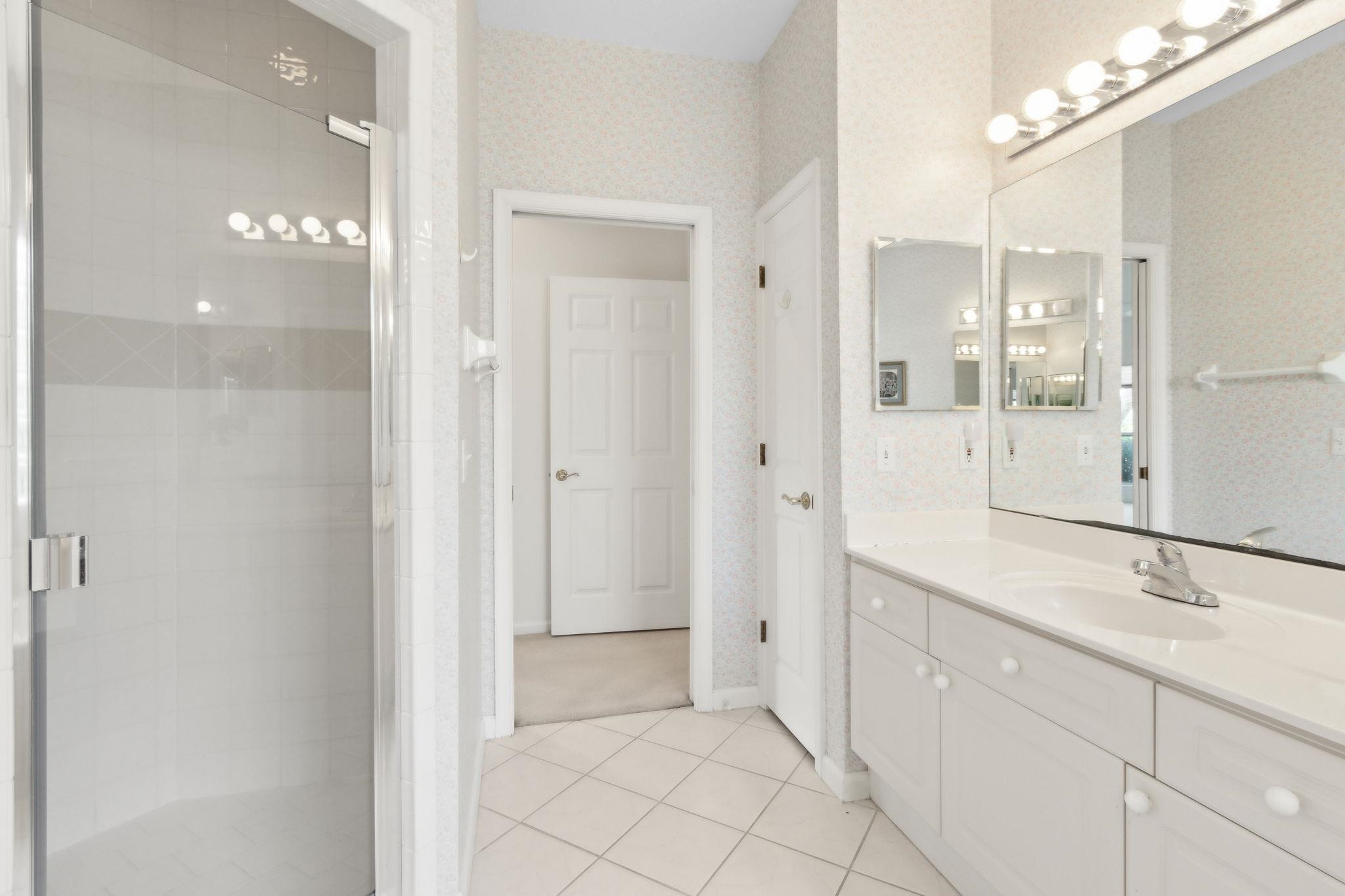 908 Birdie Way St. Augustine, FL 32080 - Photo 44 of 68 a spacious bathroom with a shower and a sink