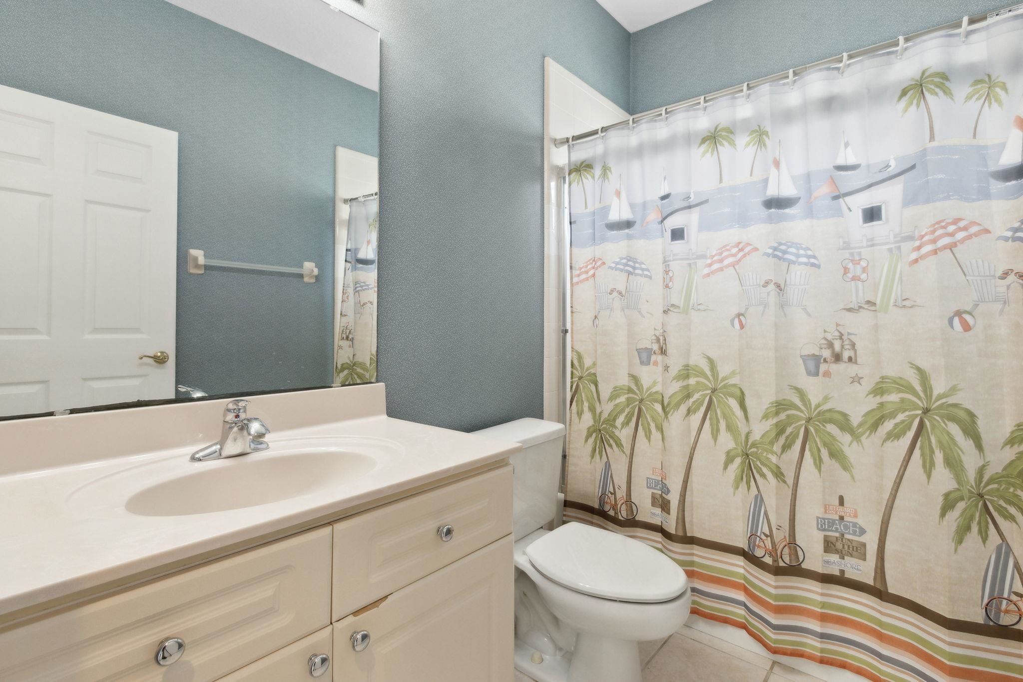 908 Birdie Way St. Augustine, FL 32080 - Photo 50 of 68 a bathroom with a granite countertop sink a toilet and a shower