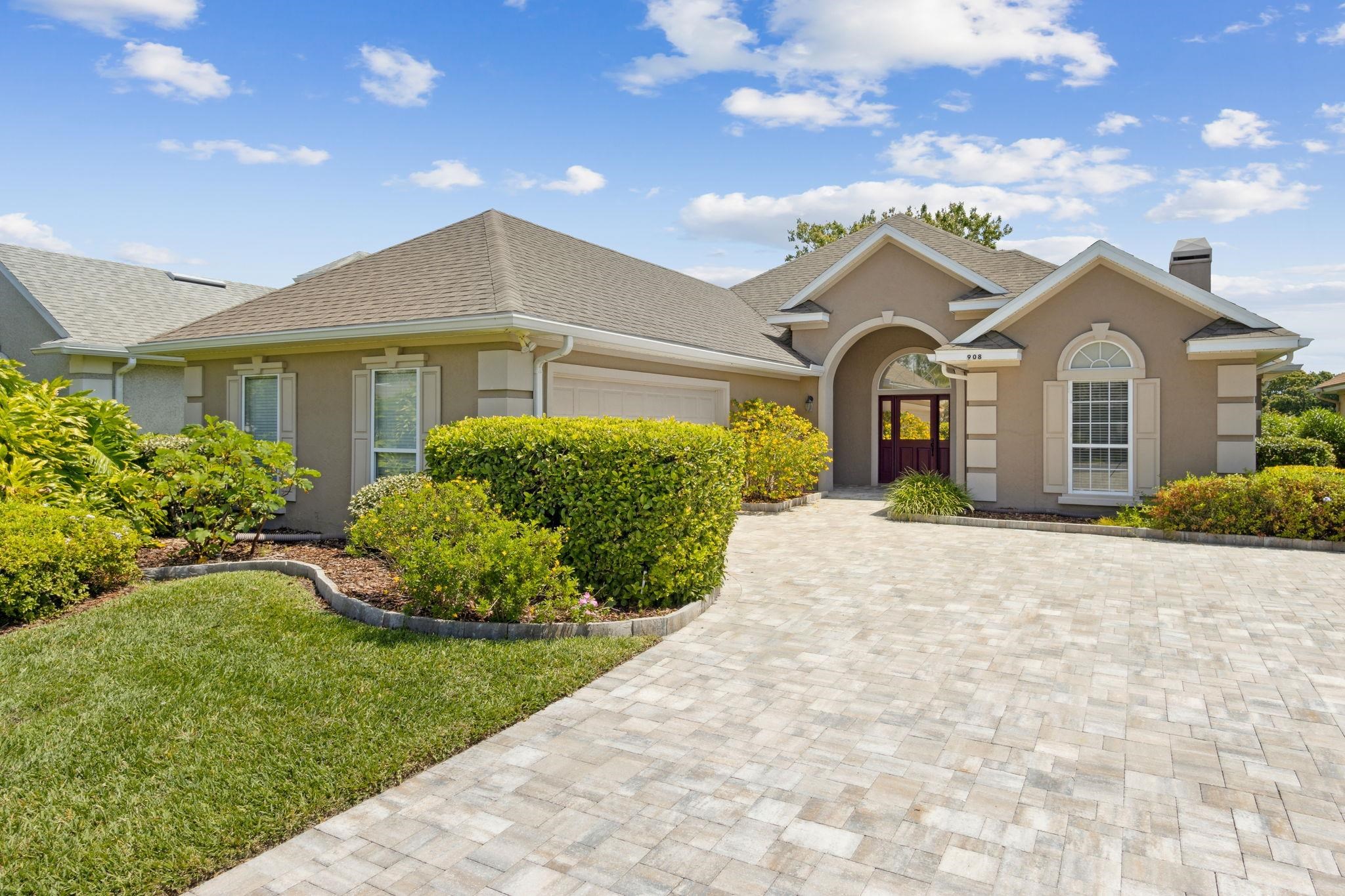 908 Birdie Way St. Augustine, FL 32080 - Photo 5 of 68 a front view of a house with a garden