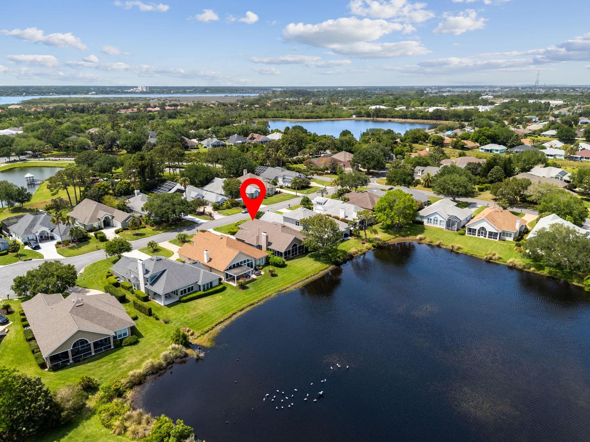 908 Birdie Way St. Augustine, FL 32080 - Photo 58 of 68 an aerial view of a houses with a lake view