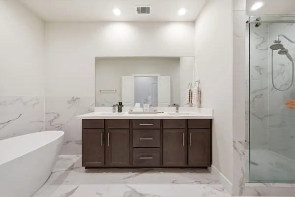 a bathroom with a double vanity sink mirror and toilet