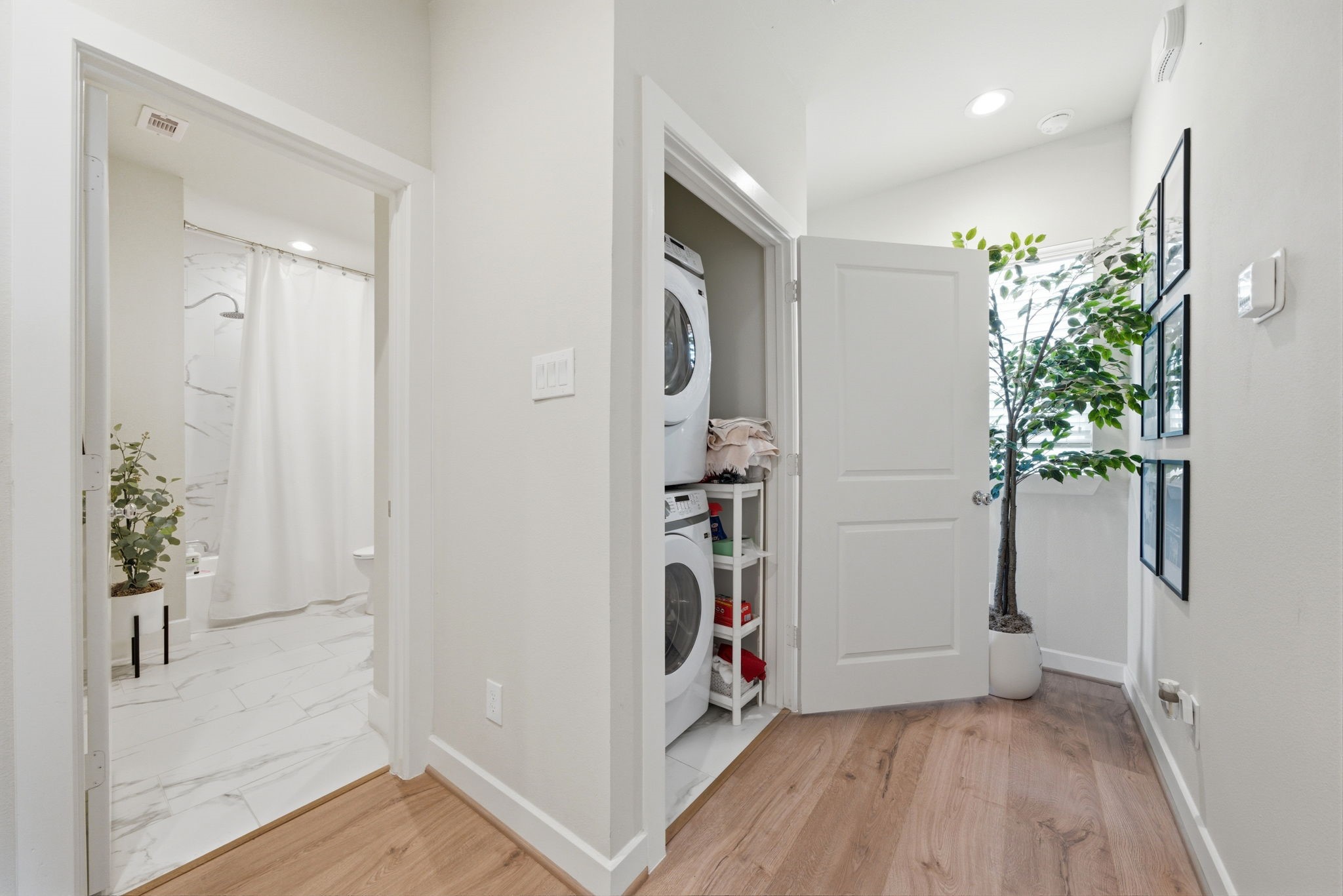 5929 Haring Lane Houston, TX 77091 - Photo 20 of 25 a view of a hallway with wooden floor and a potted plant