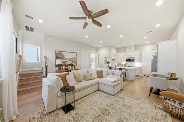 a living room with furniture and kitchen view