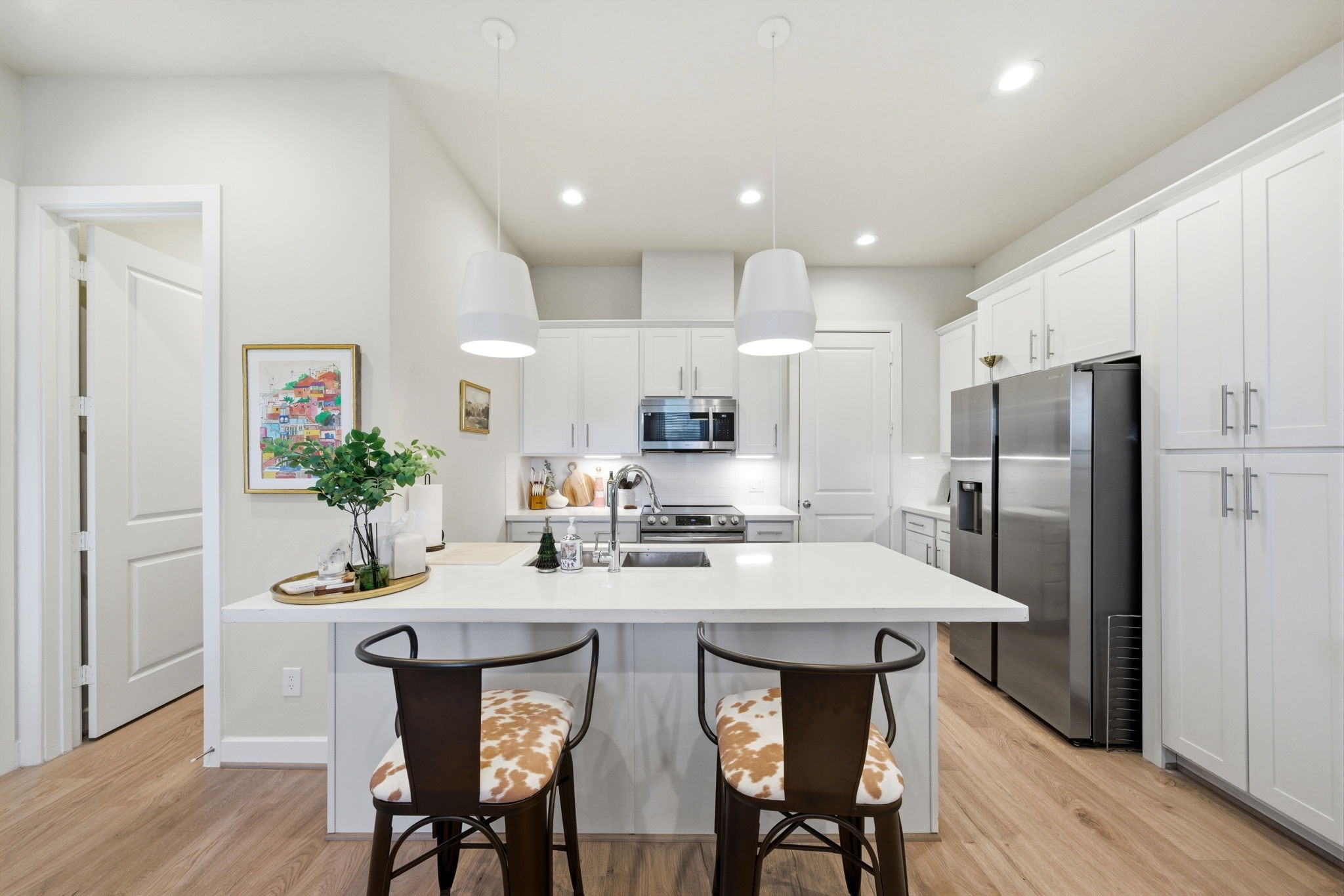 5929 Haring Lane Houston, TX 77091 - Photo 7 of 25 a kitchen with refrigerator cabinets dining table and chairs