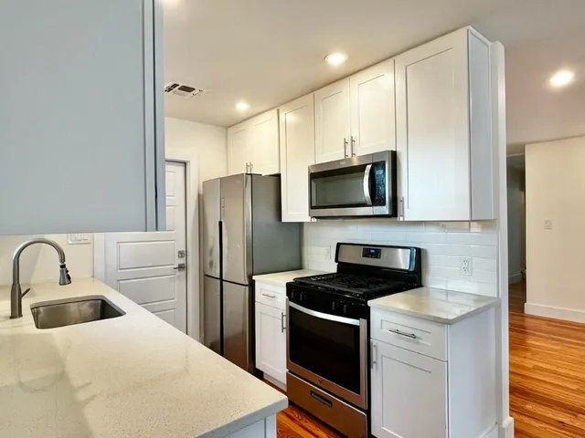 a kitchen with a refrigerator sink and microwave