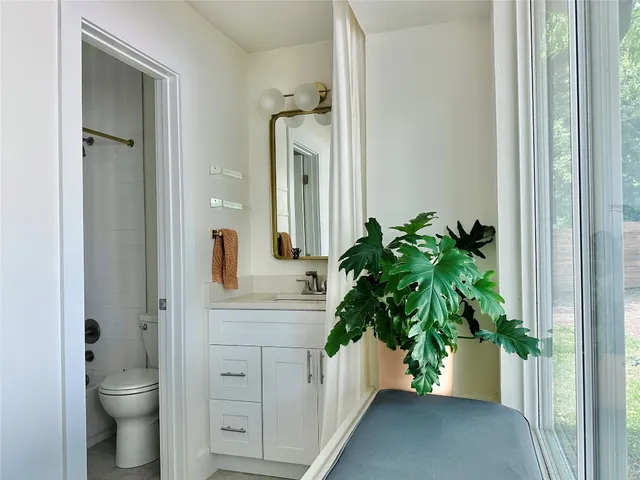 a bathroom with a toilet a sink and mirror