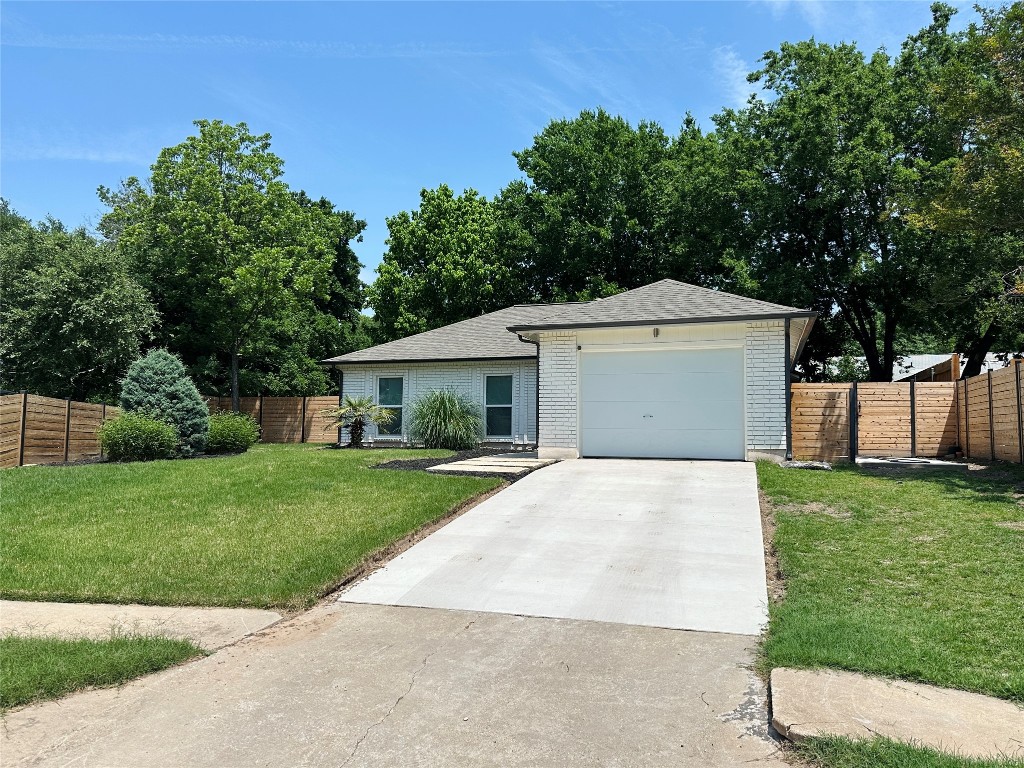 4504 West Village Court Austin, TX 78744 - Photo 18 of 18 a front view of a house with a yard and trees