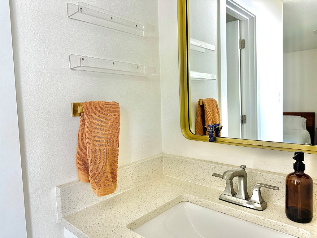 4504 West Village Court Austin, TX 78744 - Photo 7 of 18 a bathroom with a sink and a mirror