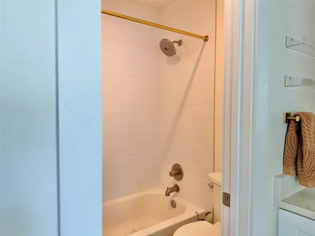 a bathroom with a shower and a tub