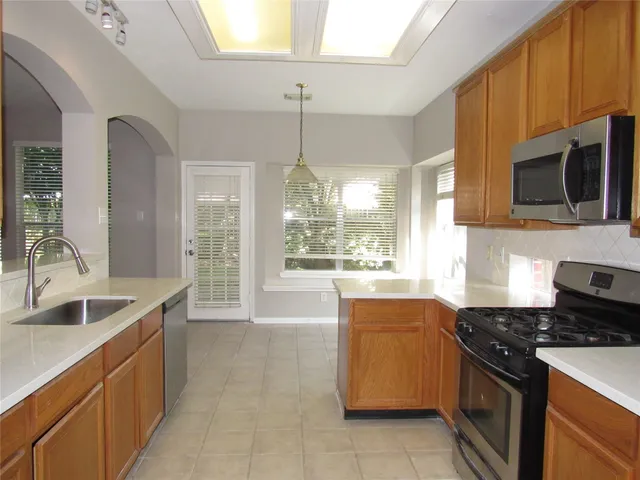 a kitchen that has a sink and a stove