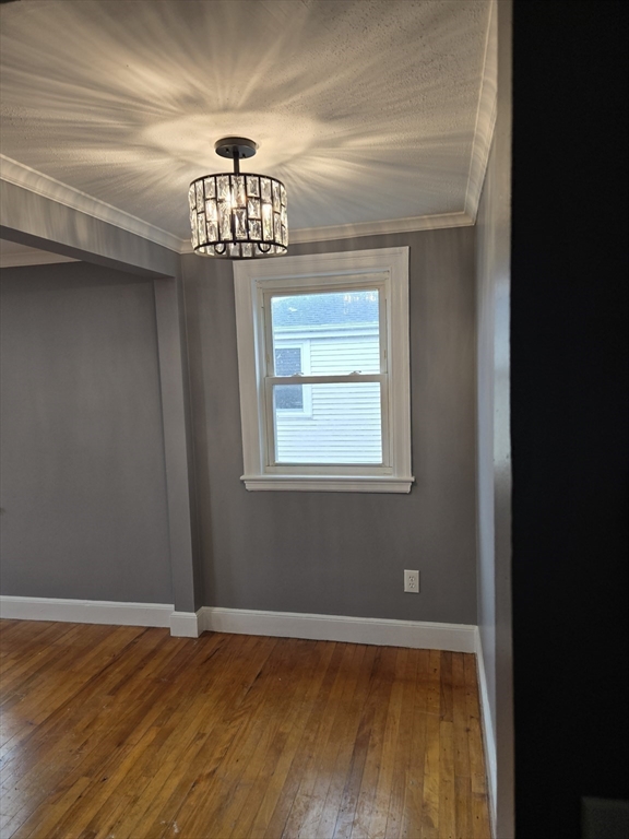114 Faraday Street, Unit 2 Boston, MA 02136 - Photo 14 of 25 a view of an empty room with wooden floor and a window