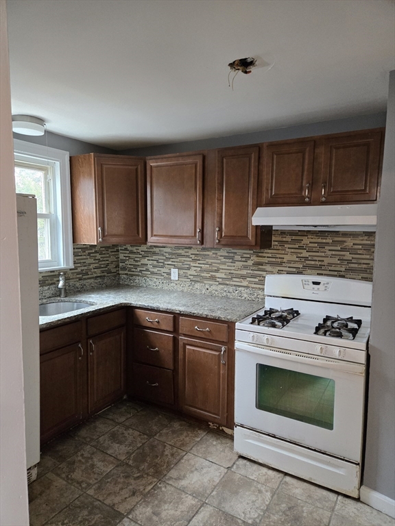 114 Faraday Street, Unit 2 Boston, MA 02136 - Photo 15 of 29 a kitchen with granite countertop a stove top oven sink and cabinets