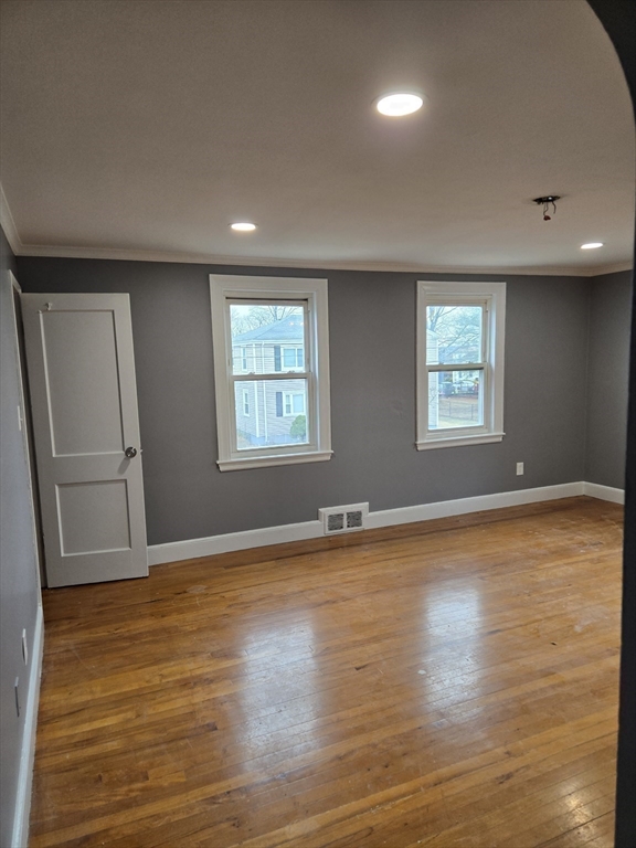 114 Faraday Street, Unit 2 Boston, MA 02136 - Photo 20 of 29 an empty room with wooden floor and windows