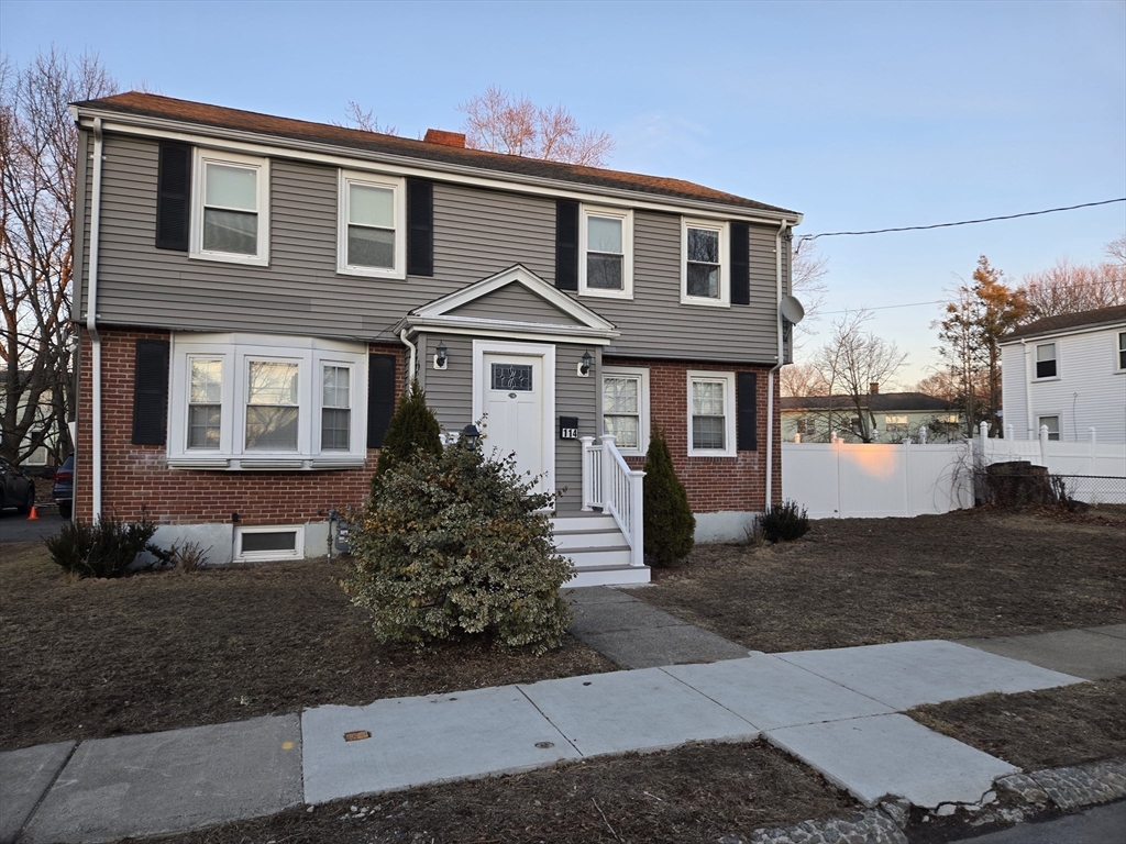 114 Faraday Street, Unit 2 Boston, MA 02136 - Photo 2 of 29 a front view of a house with a yard and garage