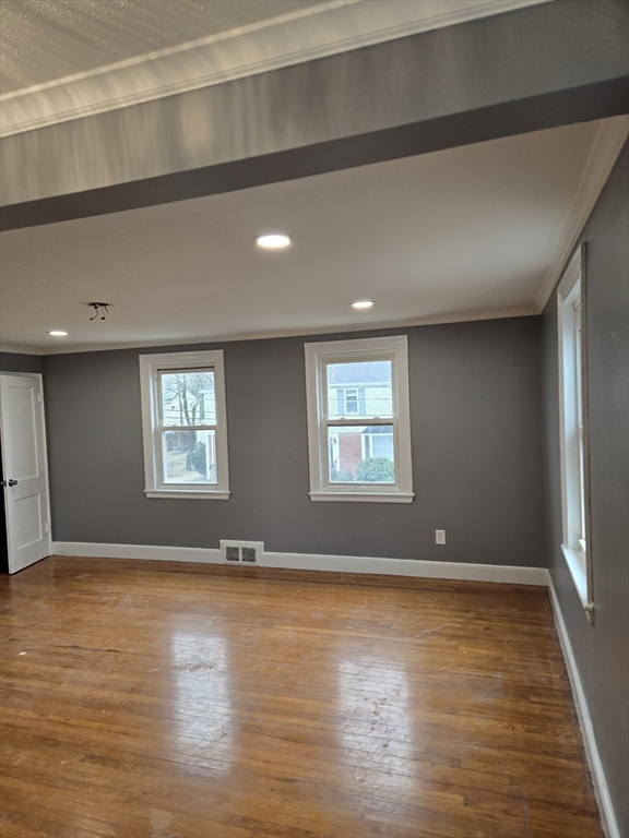 114 Faraday Street, Unit 2 Boston, MA 02136 - Photo 21 of 29 an empty room with wooden floor and windows