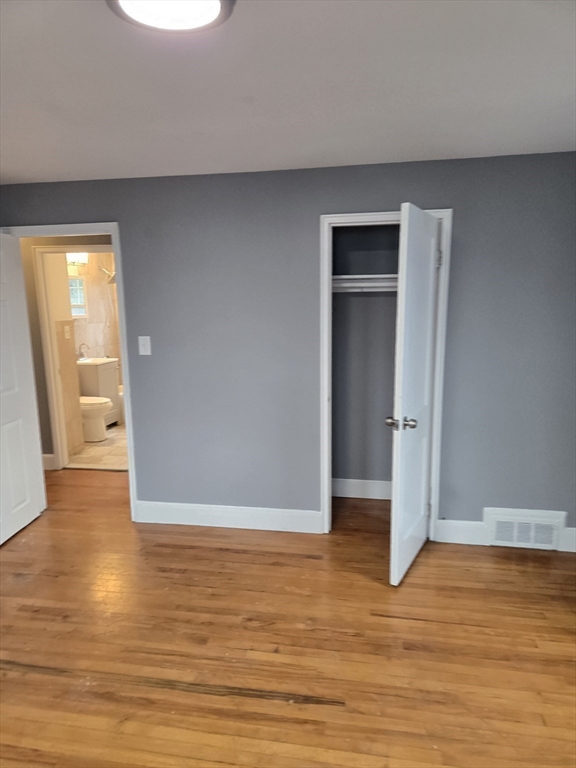 114 Faraday Street, Unit 2 Boston, MA 02136 - Photo 27 of 29 a view of an empty room with wooden floor