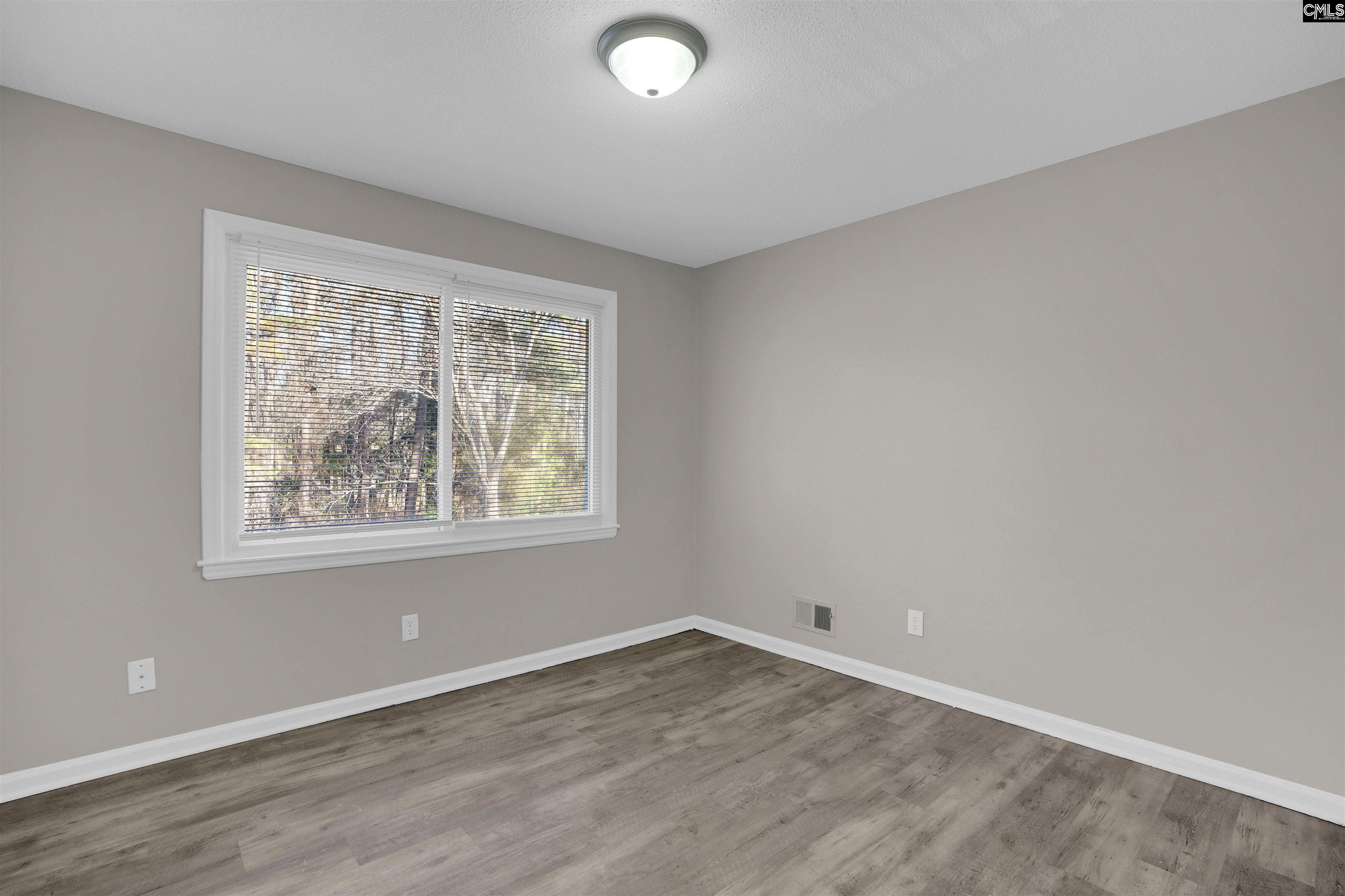 2620 Pleasant Ridge Drive Columbia, SC 29209 - Photo 33 of 37 an empty room with wooden floor and windows