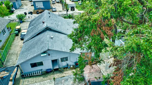 an aerial view of a house with a yard
