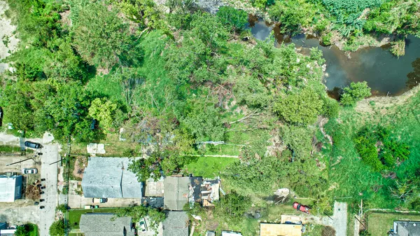 an aerial view of a houses with yard