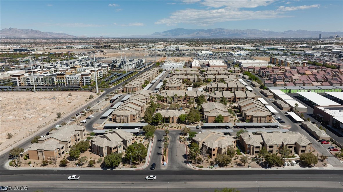 6650 West Warm Springs Road, Unit 2027 Las Vegas, NV 89118 - Photo 25 of 29 An aerial perspective reveals a vast community under clear skies with distant mountains.