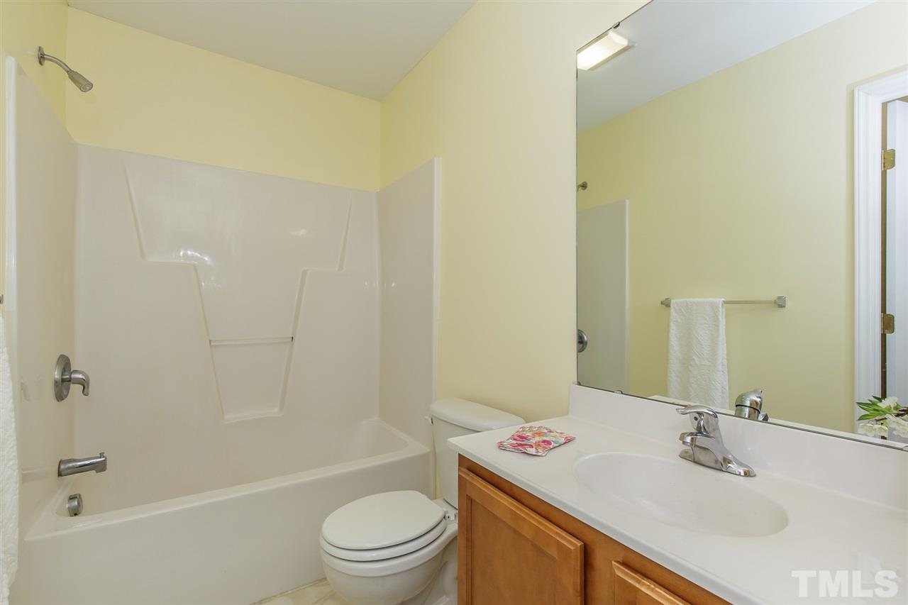 4105 Neal Road, Unit C Durham, NC 27705 - Photo 14 of 22 a bathroom with a sink a toilet and shower