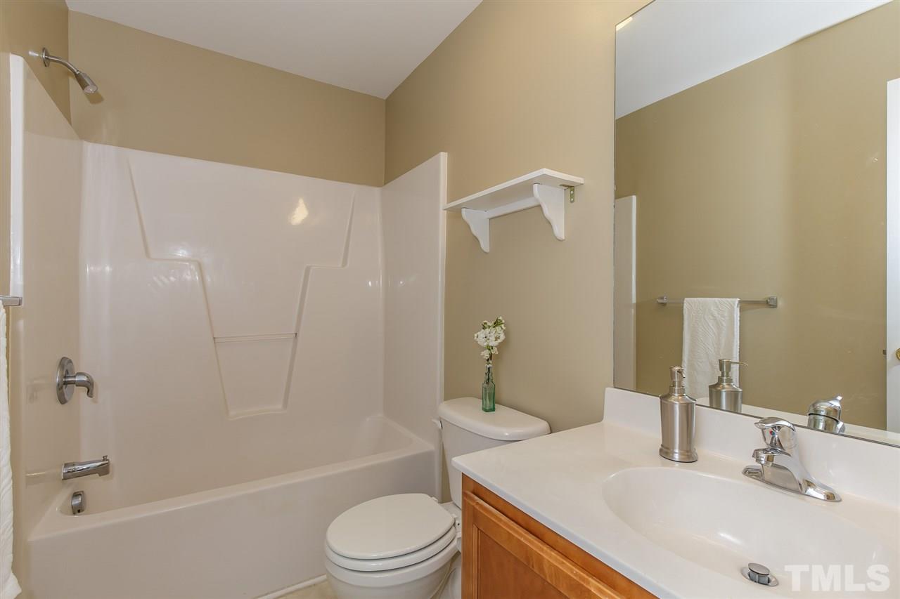 4105 Neal Road, Unit C Durham, NC 27705 - Photo 16 of 22 a bathroom with a sink a toilet and shower
