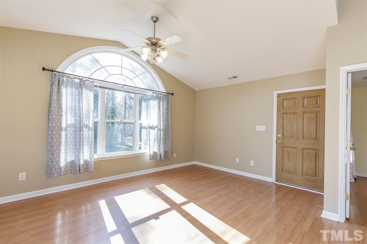 4105 Neal Road, Unit C Durham, NC 27705 - Photo 5 of 22 an empty room with wooden floor fan and windows