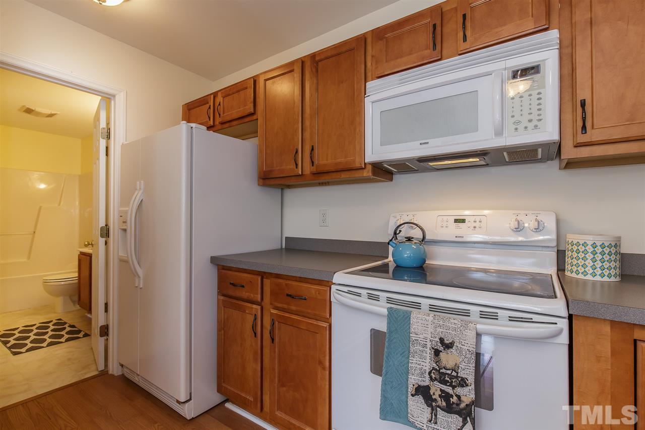 4105 Neal Road, Unit C Durham, NC 27705 - Photo 7 of 22 a kitchen with stainless steel appliances granite countertop a refrigerator and a stove top oven
