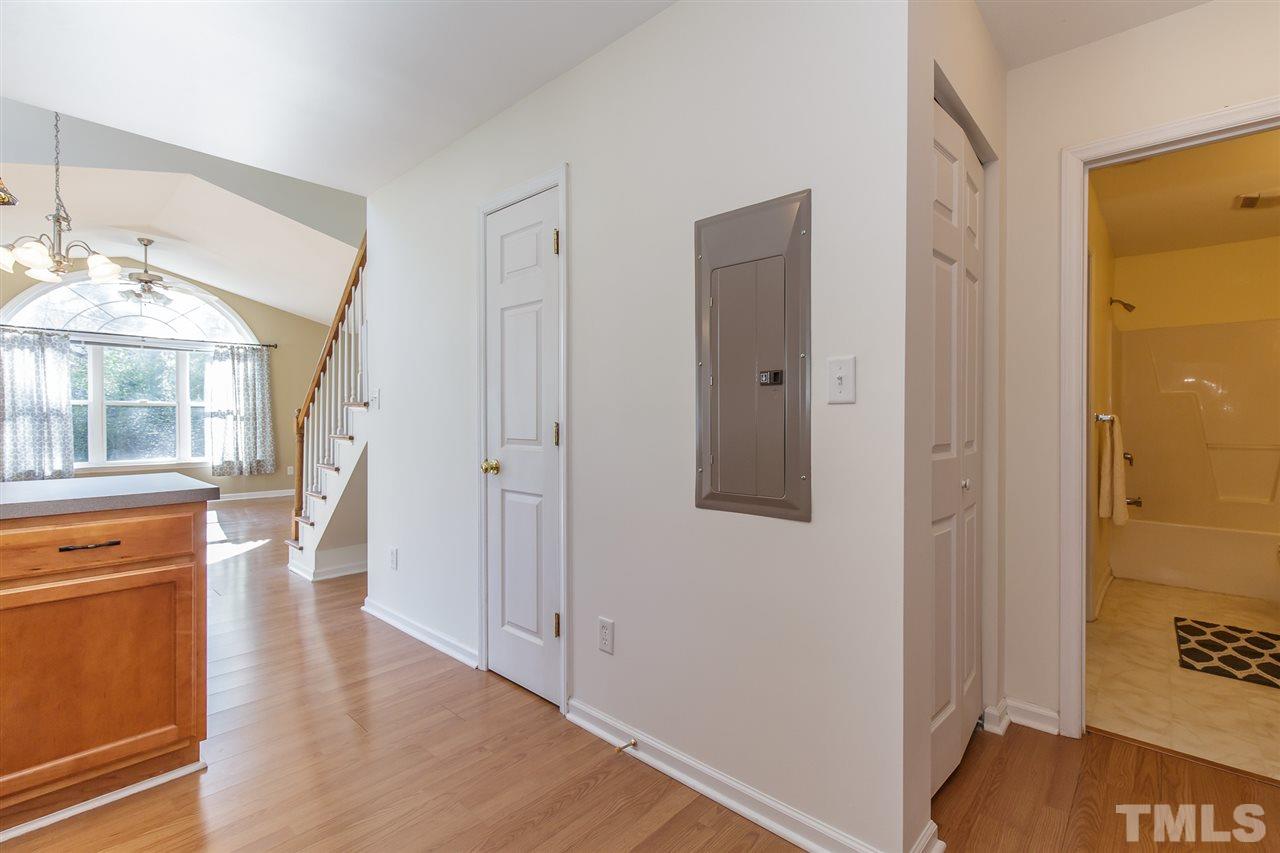 4105 Neal Road, Unit C Durham, NC 27705 - Photo 9 of 22 a view of a hallway with wooden floor and a living room