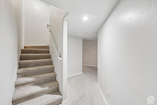 3863 East Cascade Road, Unit 3 Eagle Mountain, UT 84005 - Photo 26 of 37 Carpeted staircase with a white handrail, recessed lighting, and light-toned wall finishes