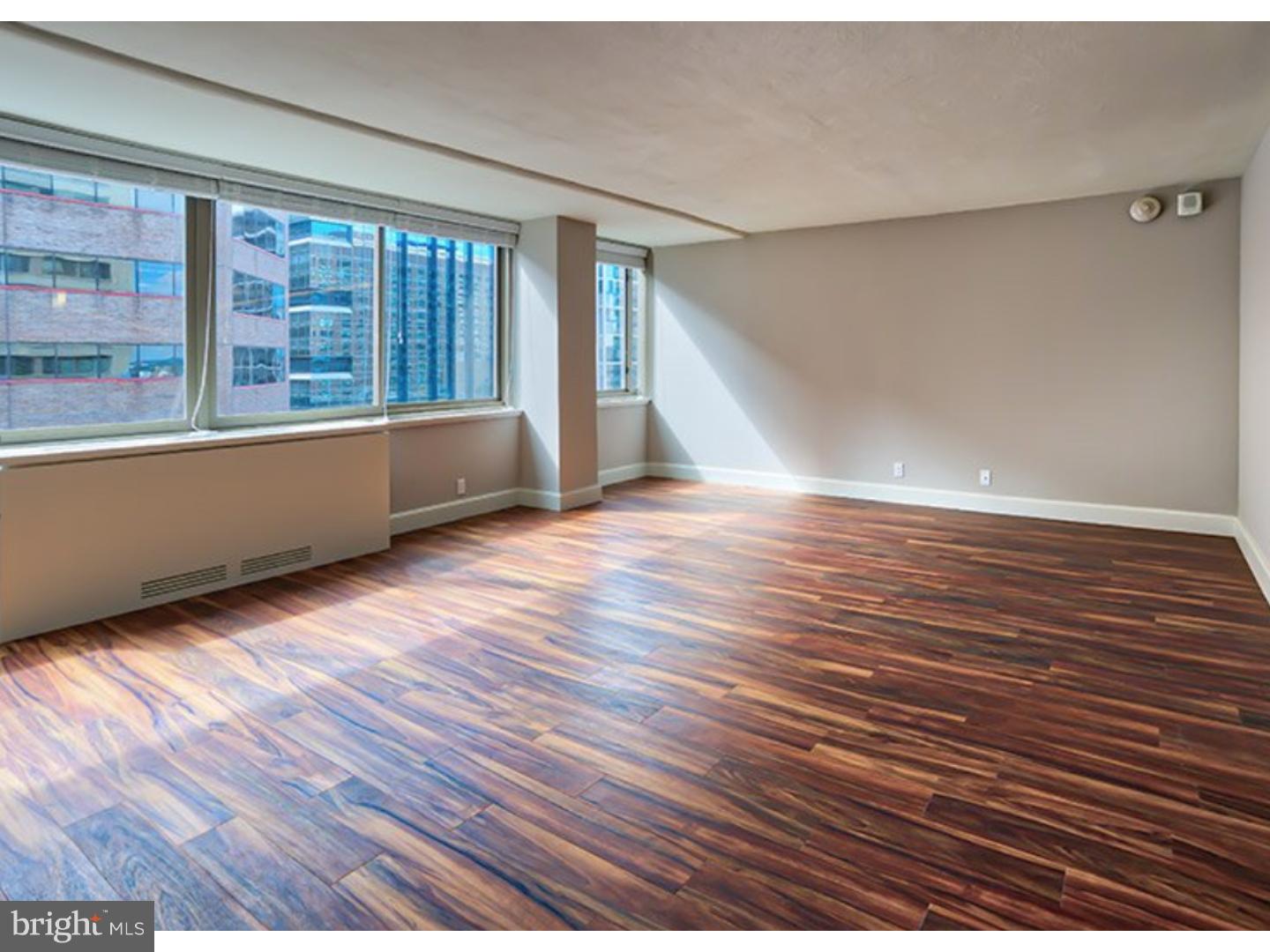 1815 John F Kennedy Boulevard, Unit 1B819 Philadelphia, PA 19103 - Photo 5 of 16 a view of an empty room with wooden floor and a window