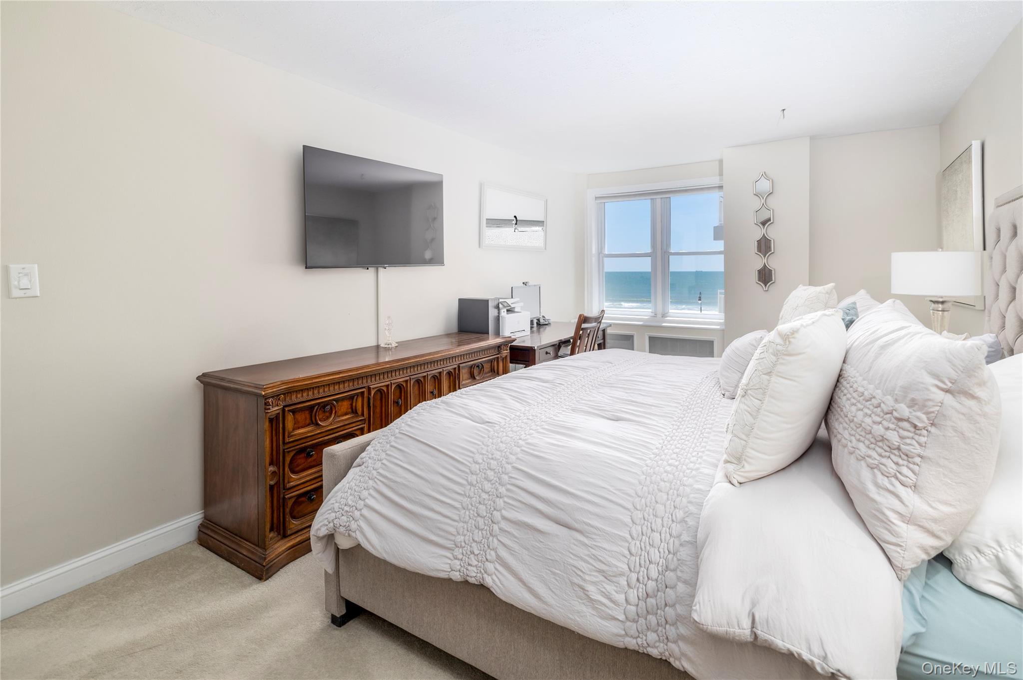 522 Shore Road, Unit 4W Long Beach, NY 11561 - Photo 15 of 33 Bedroom featuring light colored carpet, baseboards, and a desk