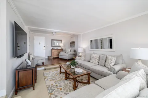 a living room with furniture wooden floor and a flat screen tv