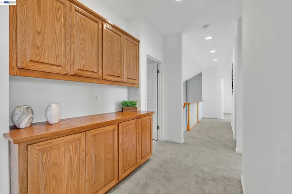 a kitchen with stainless steel appliances granite countertop a sink a refrigerator and cabinets