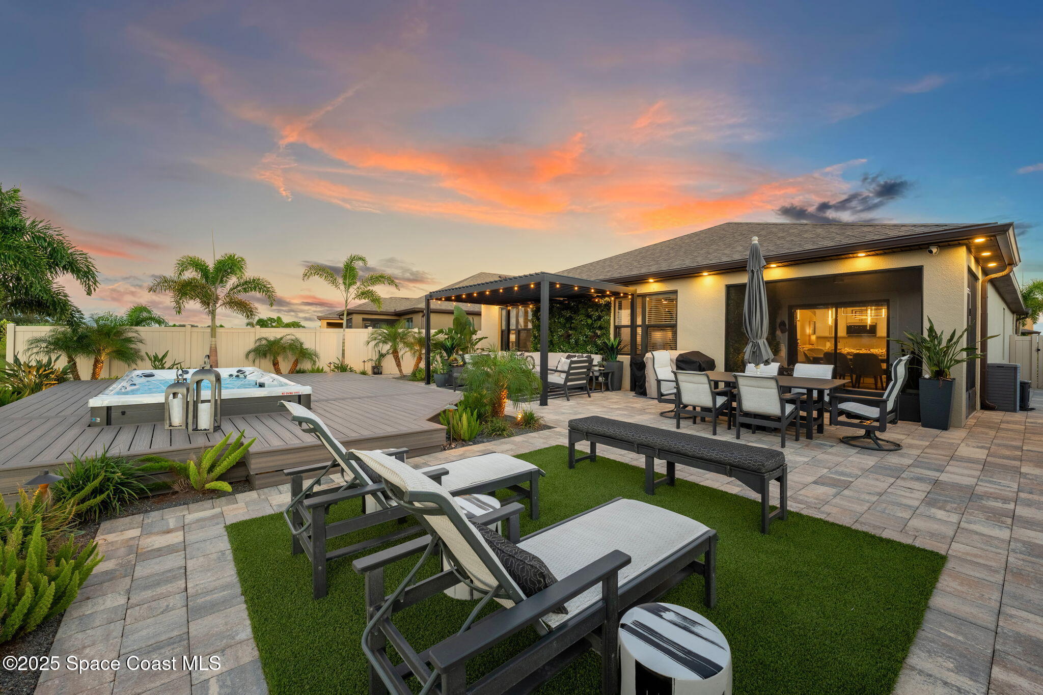2013 Farmhouse Road Southeast Palm Bay, FL 32909 - Photo 2 of 37 a view of a patio with couches table and chairs with wooden floor and fence