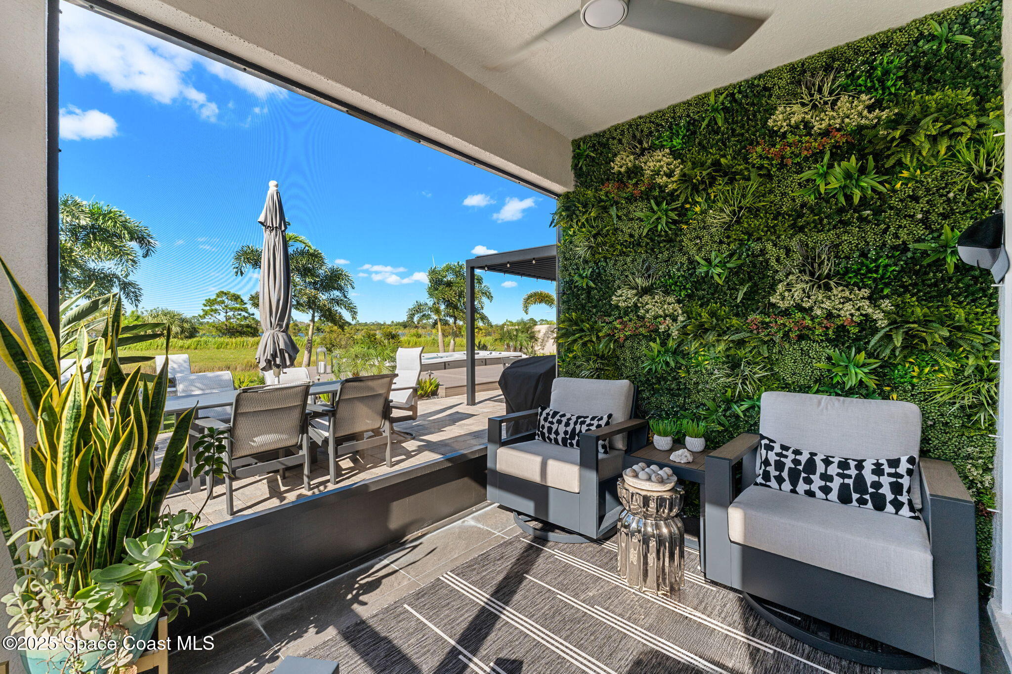 2013 Farmhouse Road Southeast Palm Bay, FL 32909 - Photo 24 of 37 a outdoor living space with furniture and a potted plant