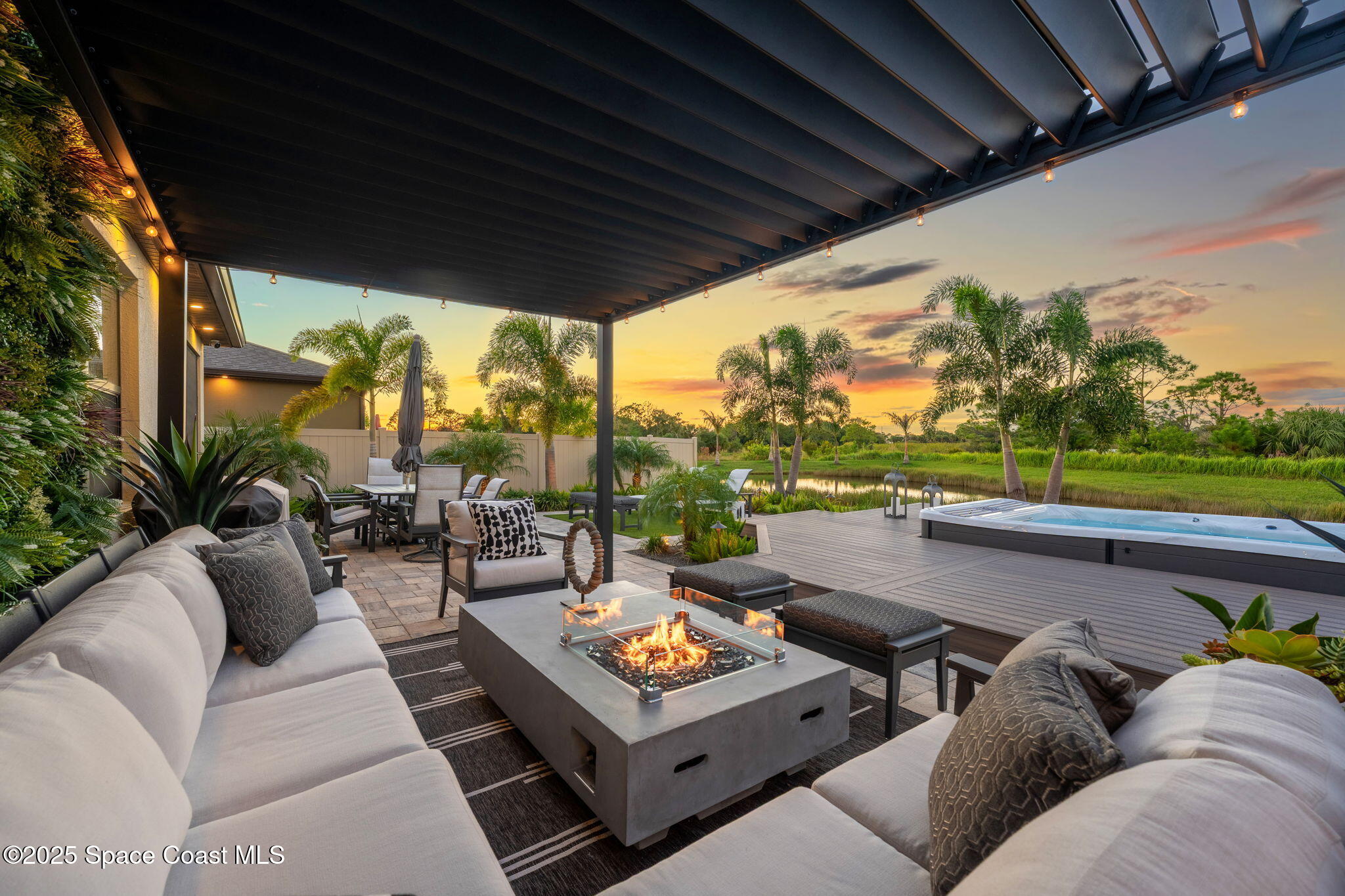 2013 Farmhouse Road Southeast Palm Bay, FL 32909 - Photo 3 of 37 a living room with patio furniture and a garden